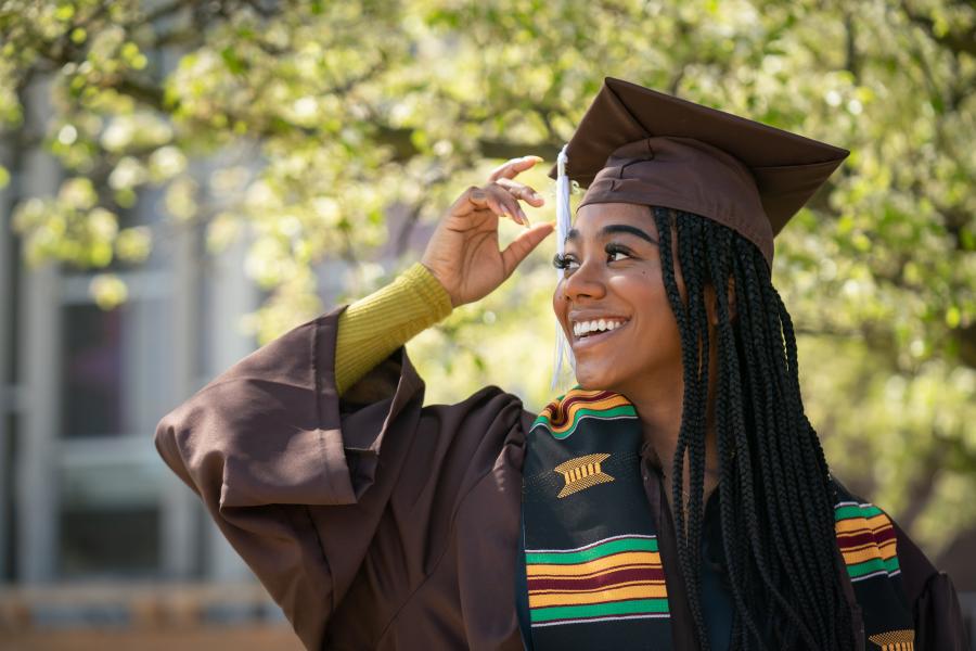 A student wearing her graduation cap and gown.